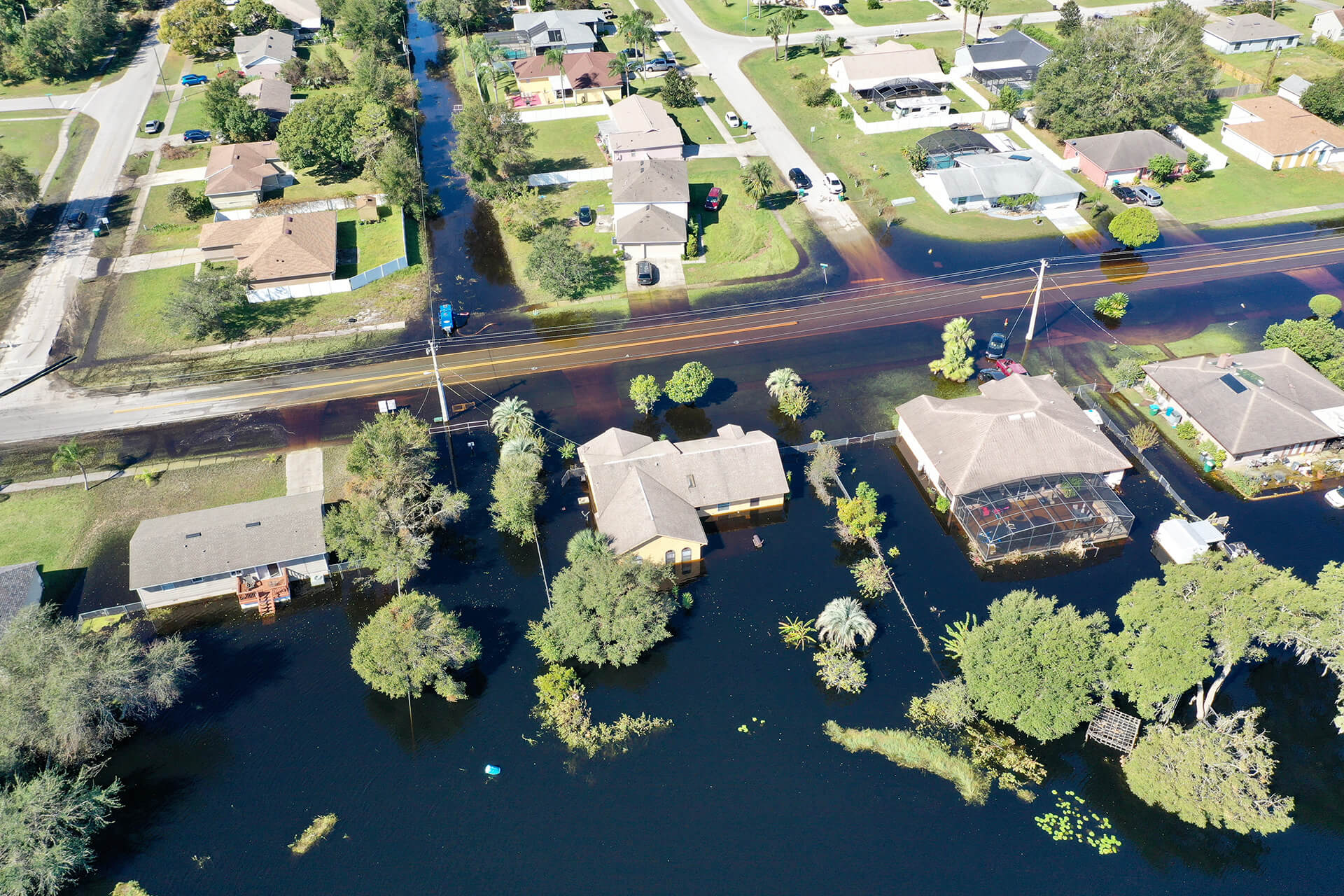 Aerial view of a suburban Georgia neighborhood with streets and homes heavily flooded, highlighting the importance of flood insurance to protect property and belongings